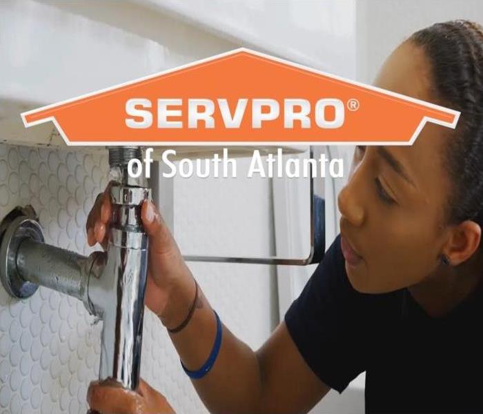 SERVPRO of South Atlanta Water Mitigation and Restoration Services - woman inspecting piping