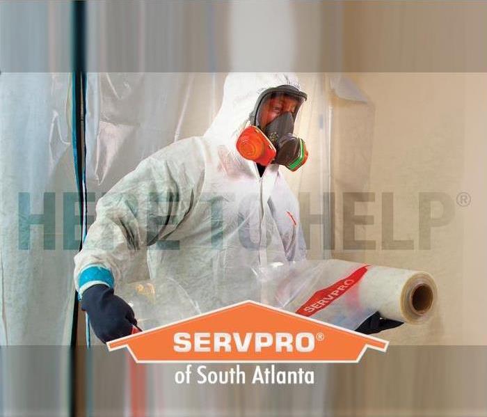 a SERVPRO employee in PPE prepping an area for cleaning